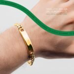 Gold tone bracelet worn on the wrist