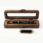 Engraved metal pen with its natural pine wood case