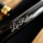 Engraved name on the barrel of the metal pen